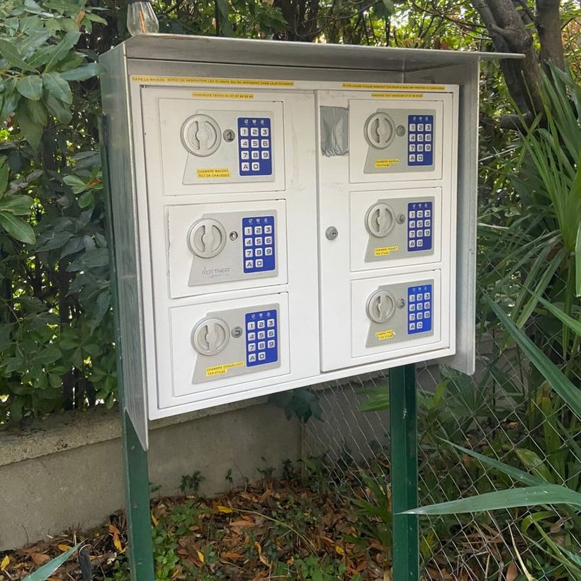 Outdoor cabinet of key safes at Le Grand Bassin, with one safe per room